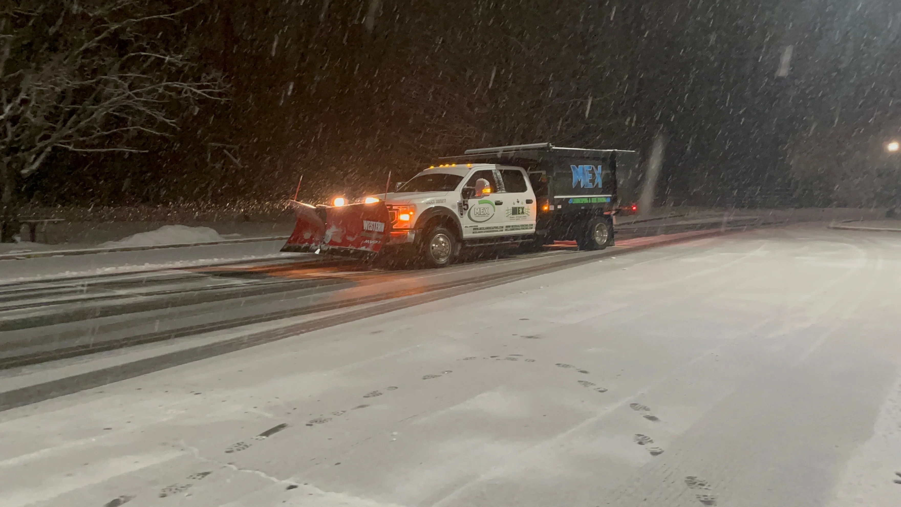 Professional commercial snow removal truck and equipment clearing parking lot in Montgomery County PA